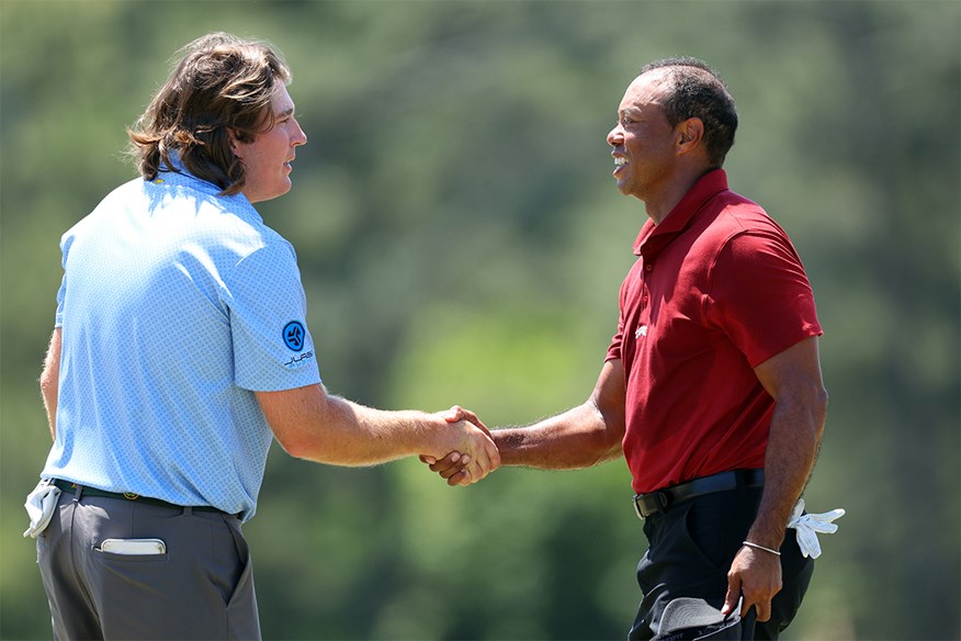 Neal Shipley and Tiger Woods exchange hand shake on the 18th green after their final round at the Masters.